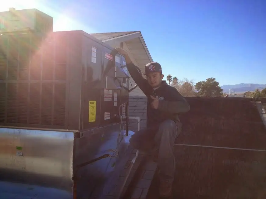 HVAC technician performing AC Tune-Up on a rooftop unit in South Heidelberg